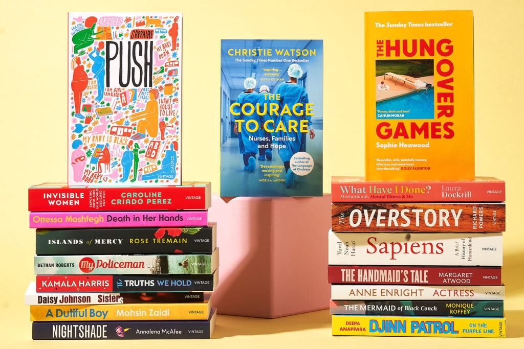 A photo of two stacks of Vintage novels, with Push by Sapphire, Courage to Care, and The Hungover Games atop them, all against a yellow background.