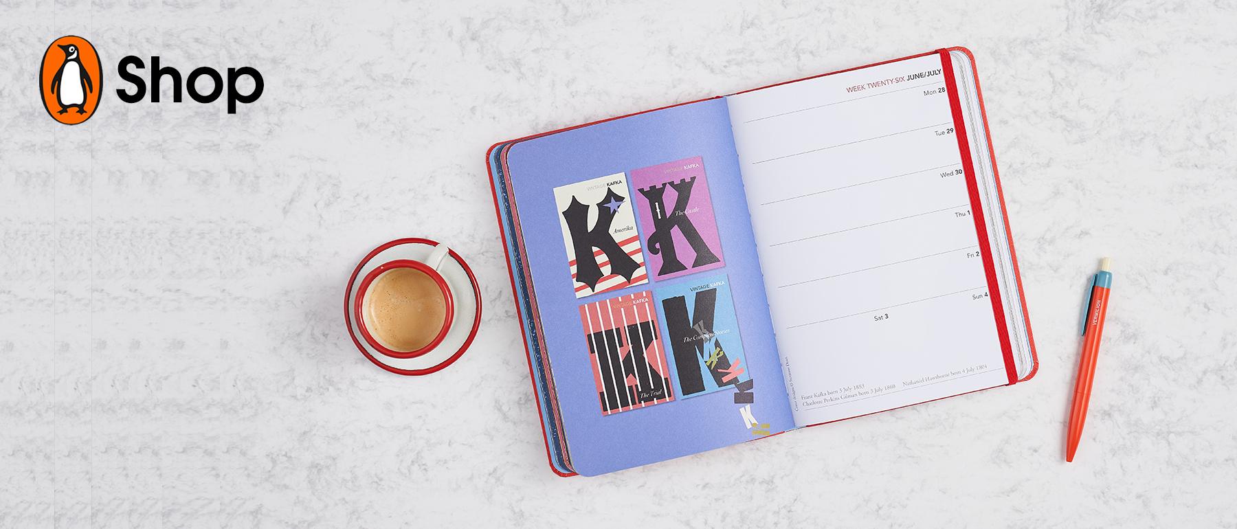 Vintage classics 2021 diary open on a page with Kafka book covers, coffee cup and pencil