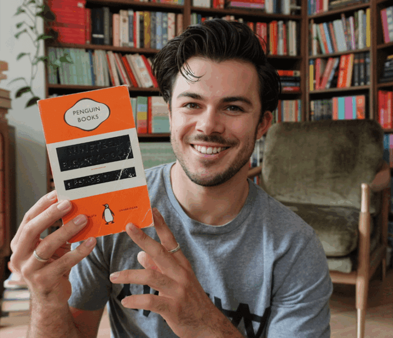 Photo of Jack Edwards holding up a copy of Nineteen Eighty-four by George Orwell