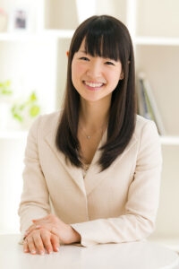Photo of Marie Kondo sitting at a table
