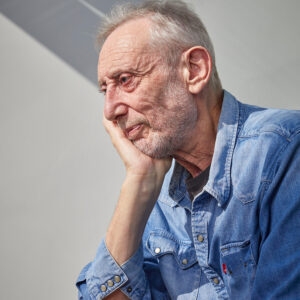 A photo of Michael Rosen in profile, against a grey background