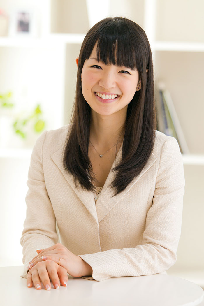 Marie Kondo sitting at a table