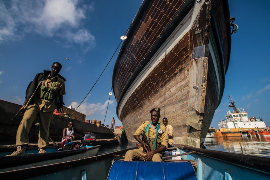 In Puntland, Somalia, a team of privately-hired guards hustles to usher us offshore before local authorities who did not want us to investigate a Thai fleet fishing in nearby waters arrive to the Bosasso port to stop us. (Photo: Fabio Nascimento, The Outlaw Ocean)