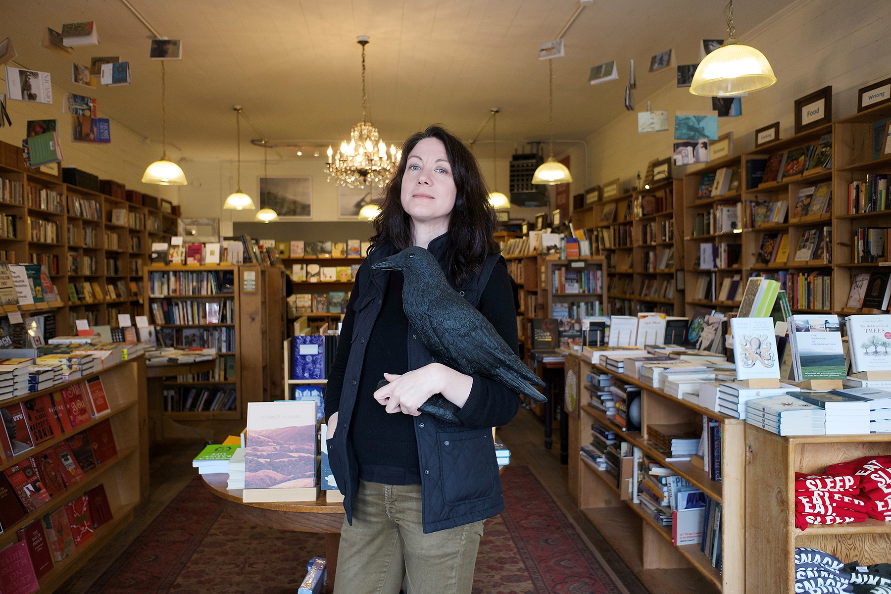 Helen Macdonald holding bird of prey in bookshop