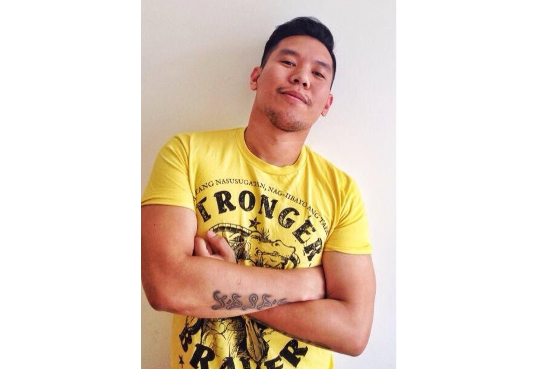 An image of a fan wearing their yellow designed T-shirt with the words 'Stronger', 'Braver' on it