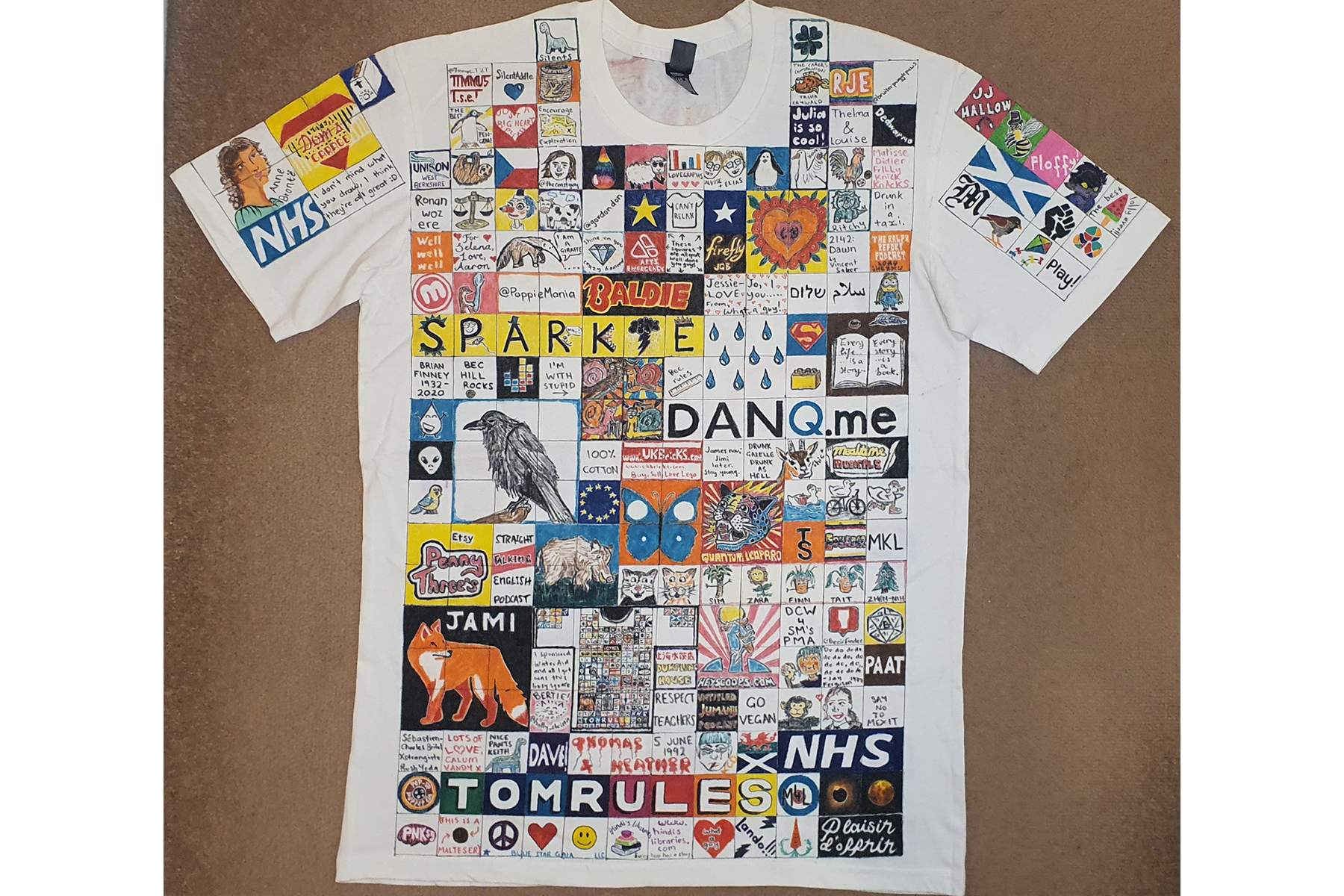 The front of a hand drawn and designed T-shirt with a patchwork of 'sponsored' images drawn on it