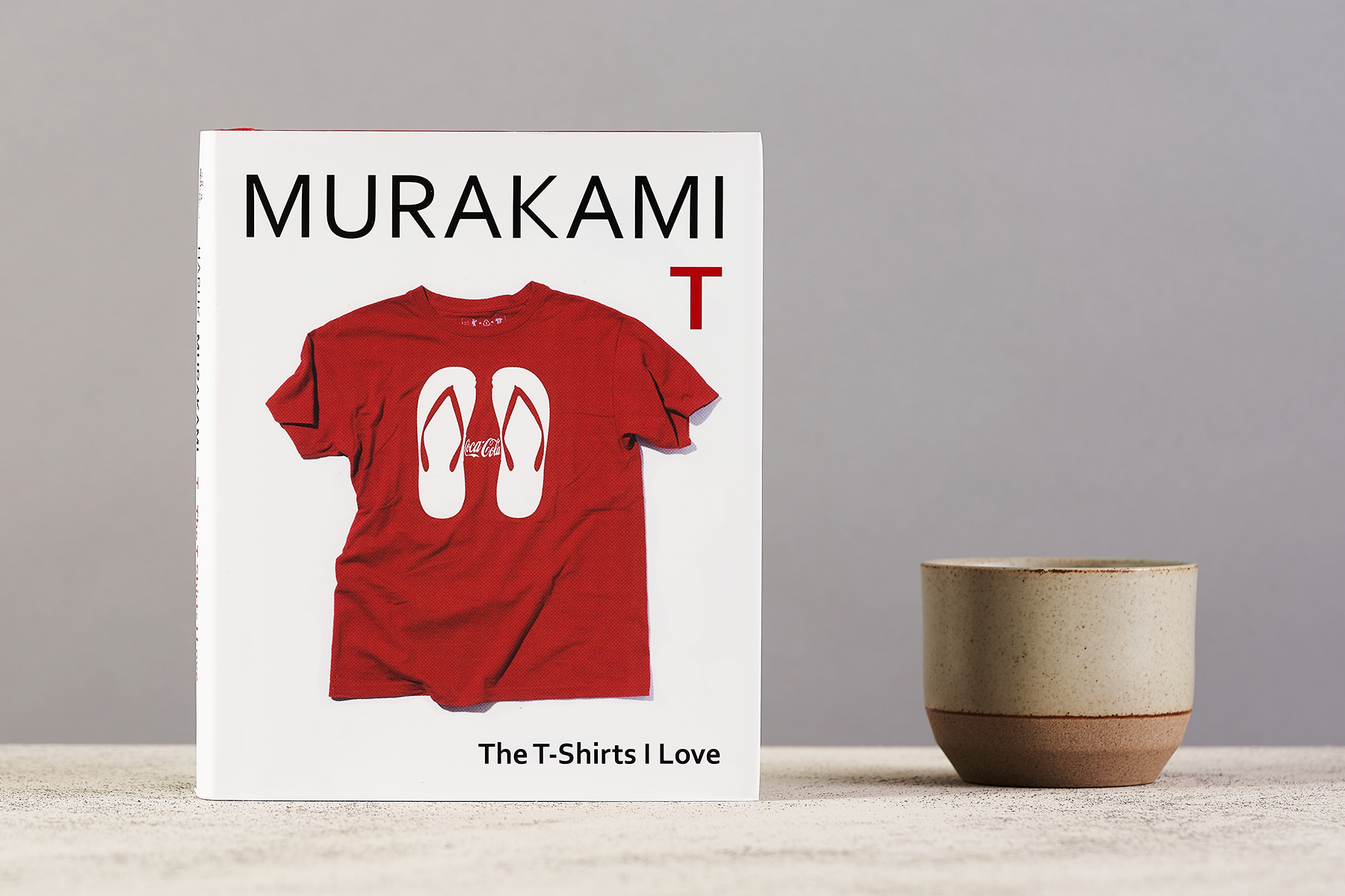 A copy of Murakami T sits next to a cup of tea