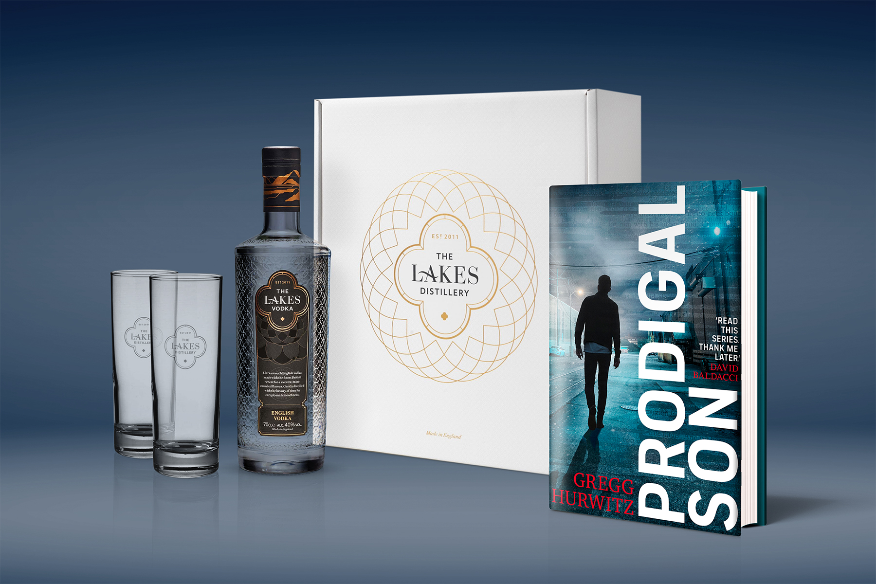A copy of Prodigal Son and a bottle of The Lakes distillery vodka with two glasses