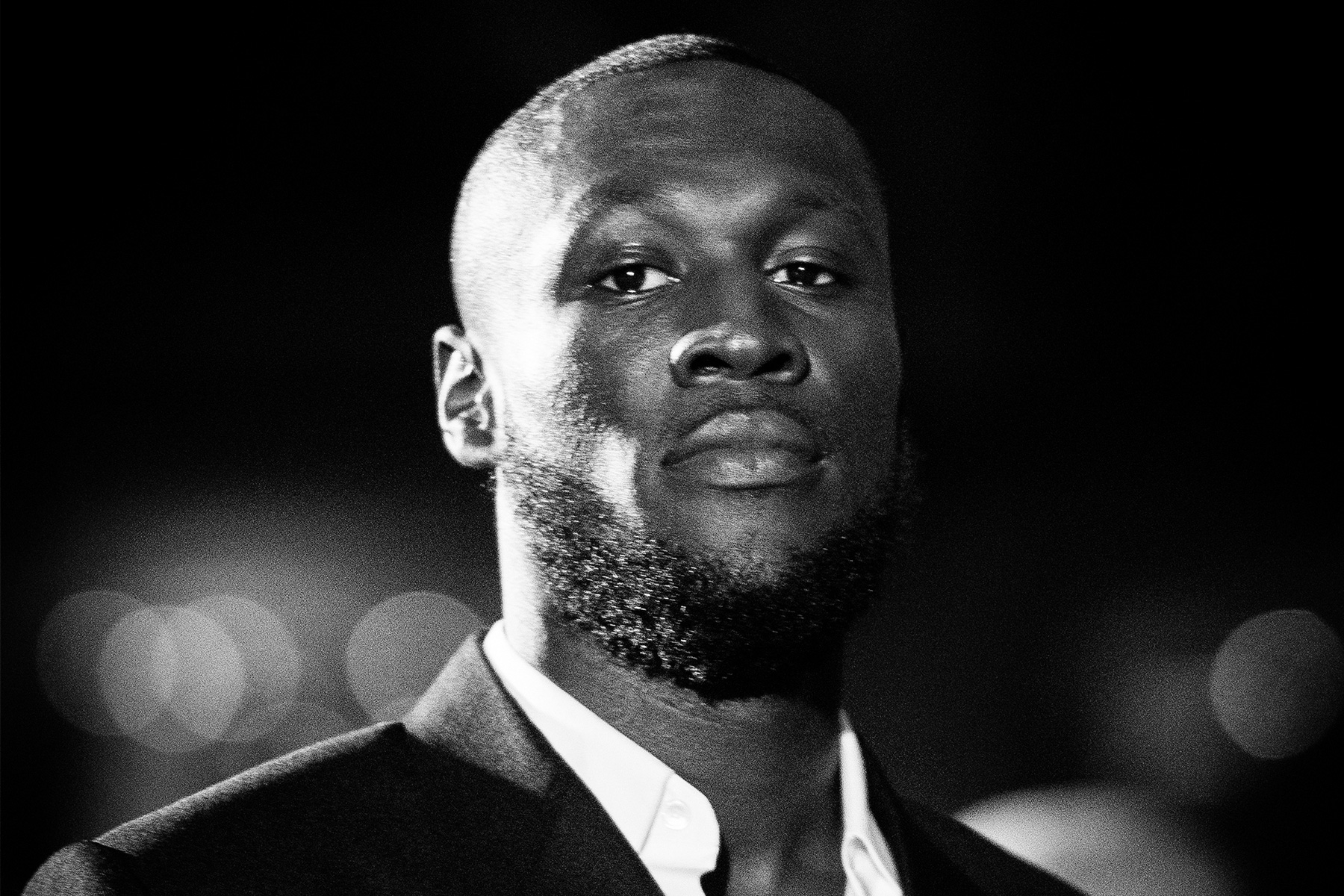 A black and white photo of Stormzy's head and shoulders