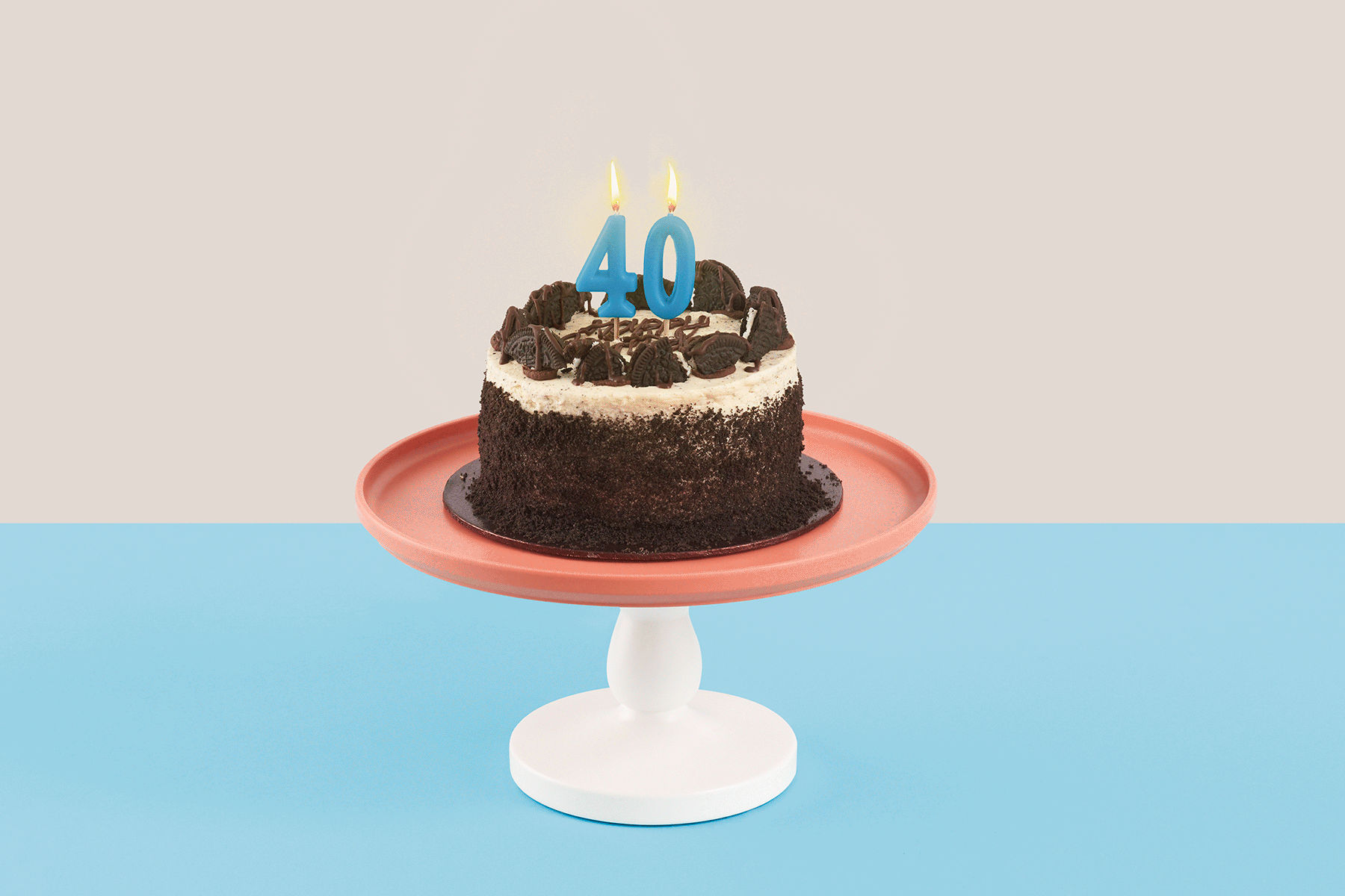 A gif of a birthday cake with '40' candles atop, with flickering flames.