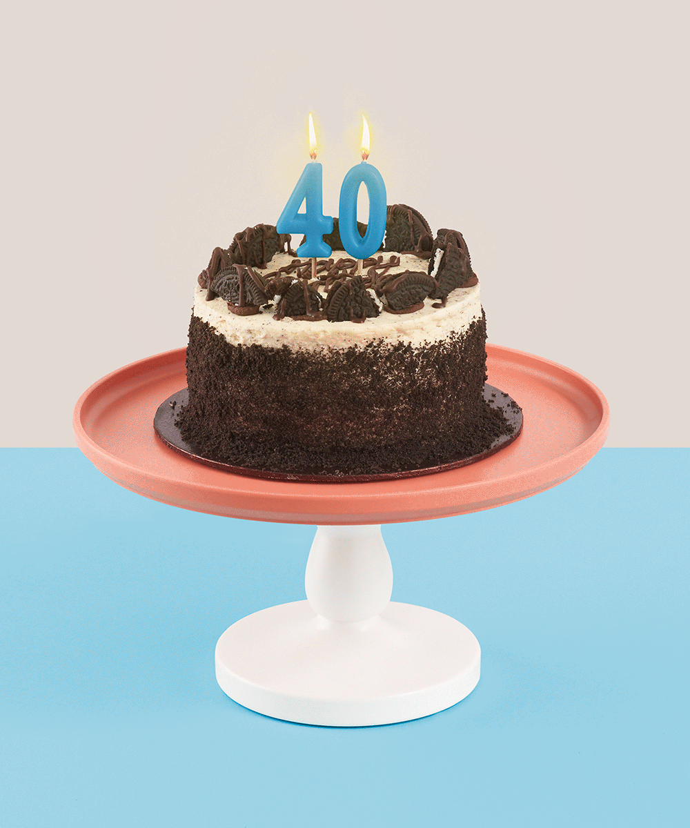 A gif of a birthday cake with '40' candles atop, with flickering flames.